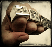 A person's hand holding a pair of rings made out of vinyl.