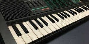 A Casio keyboard sitting on a table.