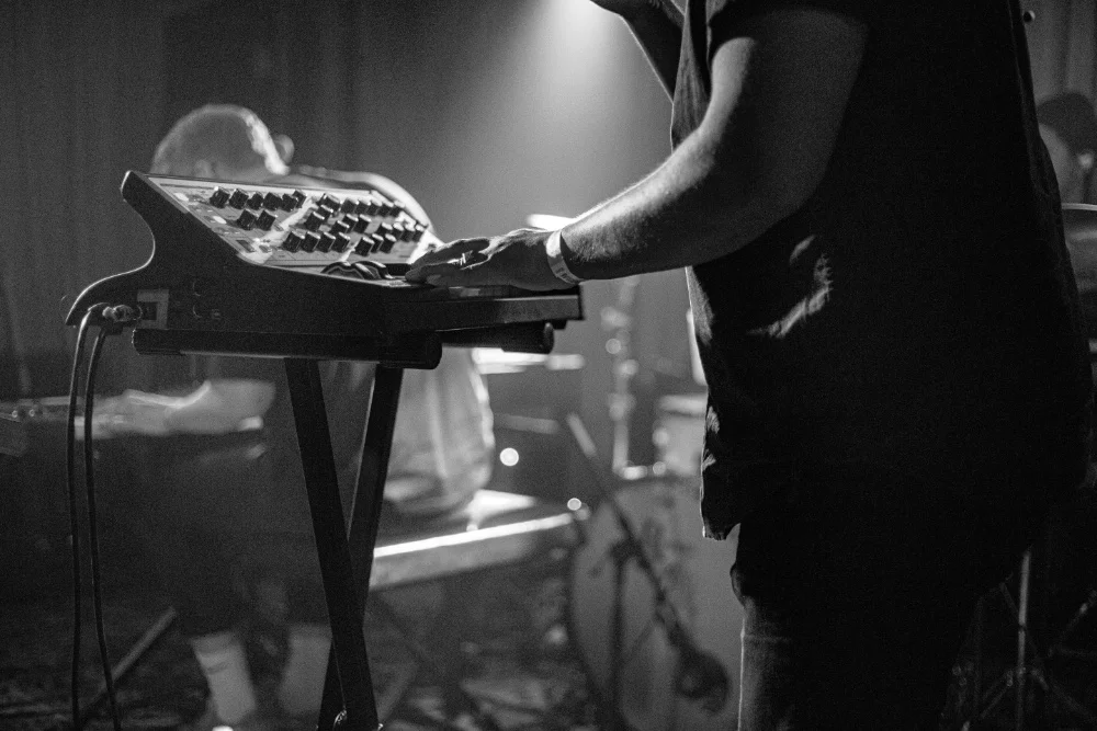 A black and white photo of a man playing a keyboard.