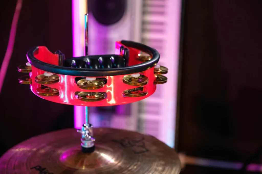 a red and black tambourine on a drum set