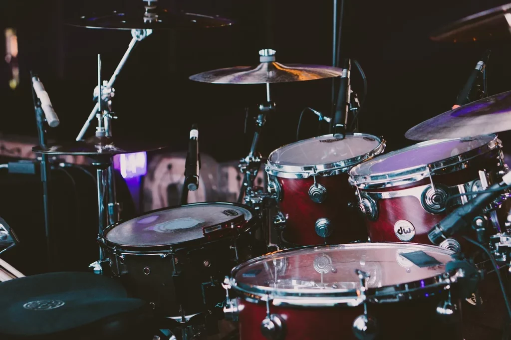 photo of a drum kit with overhead microphones positioned above it